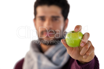 Portrait of man showing green apple