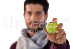 Portrait of man showing green apple