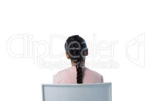 Rear view of girl sitting on chair