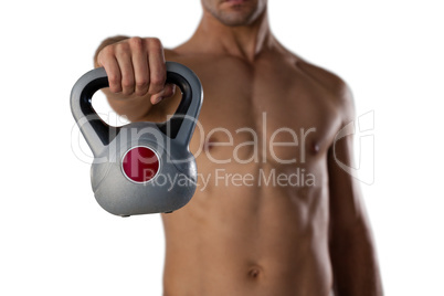 Midsection of sports player holding kettle bell