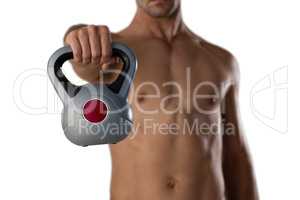 Midsection of sports player holding kettle bell