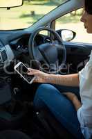 Woman using mobile phone in a car