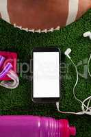 Overhead view of smart phone by American football