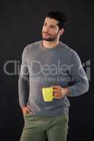 Thoughtful man holding a mug of coffee