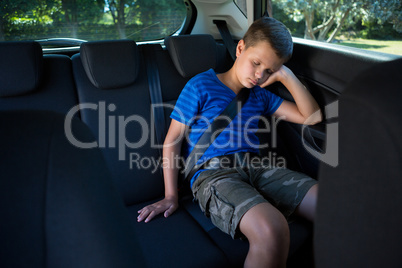 Teenage boy sleeping in the car