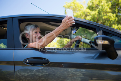 Senior woman taking selfie with mobile phone