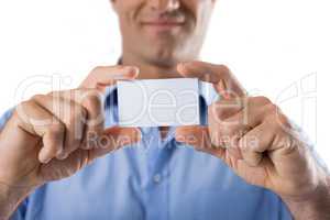 Male executive holding a blank business card