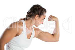 Female athlete flexing muscles