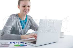 Teenage girl using laptop