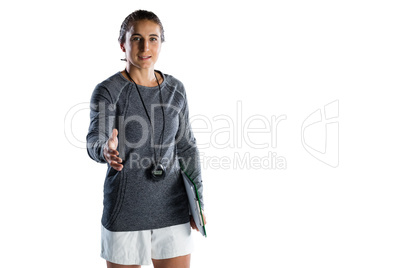 Portrait of confident female rugby coach extending arm for handshake