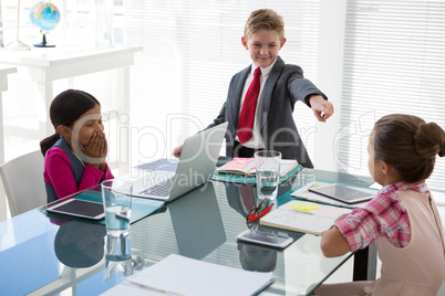 Kids as business executives interacting while meeting