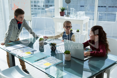 Kids as business executives interacting while meeting