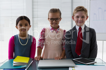 Kids as business executive smiling while standing in the office