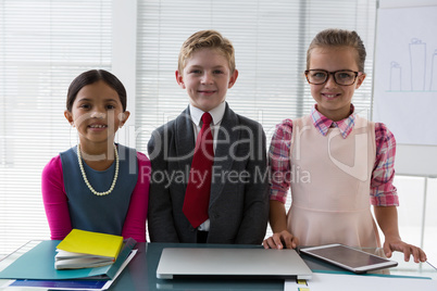 Kids as business executive smiling while standing in the office