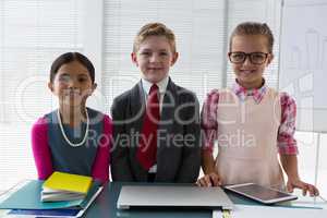 Kids as business executive smiling while standing in the office