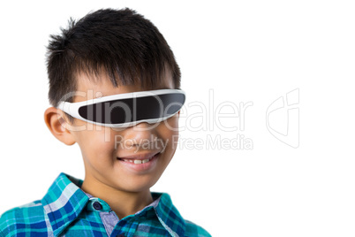 Boy using virtual reality glasses against white background