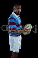 SIde view of male player holding rugby ball