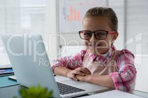 Girl as business executive smiling while sitting in office