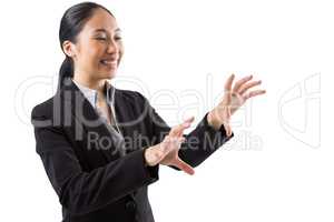 Smiling businesswoman touching the invisible screen