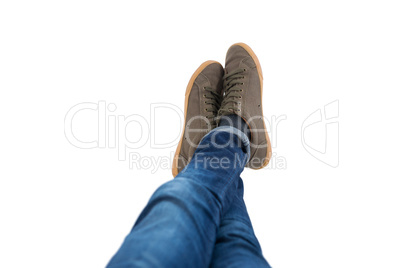 Teenage boy lying with legs crossed at ankle on white background