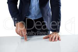 Businessman touching invisible screen on wooden table