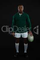 Portrait of male rugby player holding ball