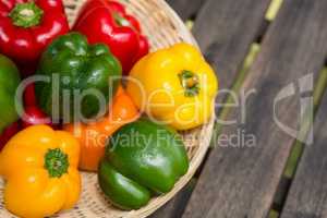 Fresh bell peppers in wicker basket