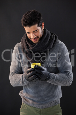 Smiling man holing a mug of coffee