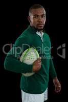 Portrait of confident male player with rugby ball