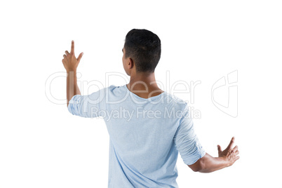 Man pretending to touch an invisible screen against white background