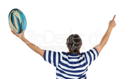 Rear view of female rugby player with arms raised