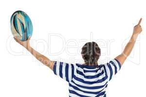 Rear view of female rugby player with arms raised