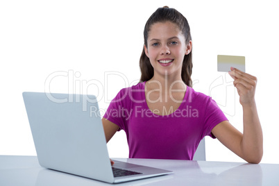 Smiling teenage girl doing online shopping