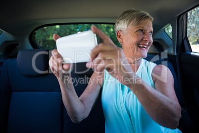 Senior woman taking selfie on mobile phone