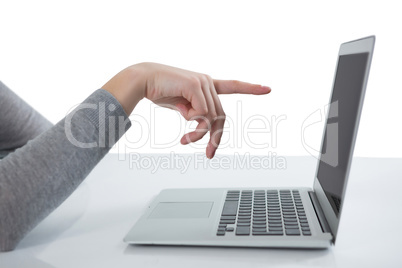 Teenage girl pointing at laptop screen