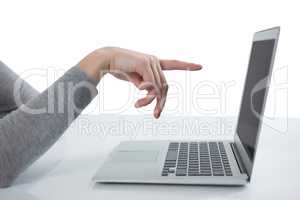 Teenage girl pointing at laptop screen