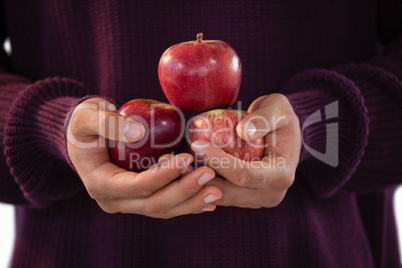 Mid-section of man holding apples