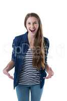 Excited teenage girl standing against white background