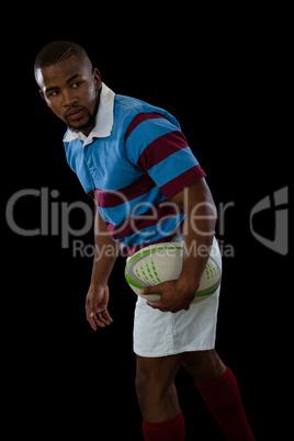 Side view of male athlete looking away while playing rugby