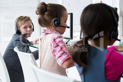 Boy as customer care executive smiling while working in the office