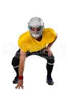 Portrait of American football player wearing helmet bending