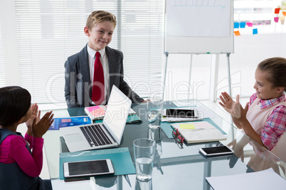 Kids as business executives interacting while meeting