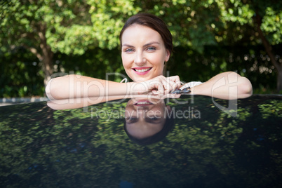 Beautiful woman leaning on a car