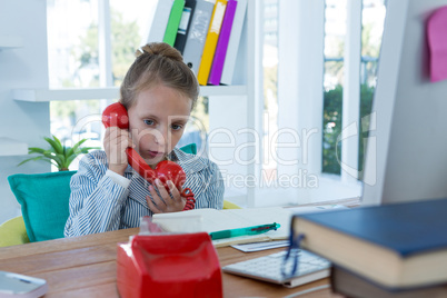 Girl as business executive talking on phone