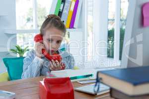 Girl as business executive talking on phone