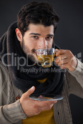 Smiling man having a cup of lemon tea