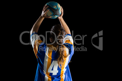 Rear view of female athlete playing rugby