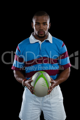 Portrait of male player holding rugby ball