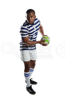 Full length of male rugby player throwing ball