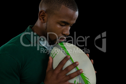 Side view of young male with rugby ball